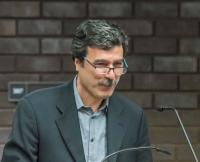 Headshot of Behrooz Ghamari Tabrizi at a podium
