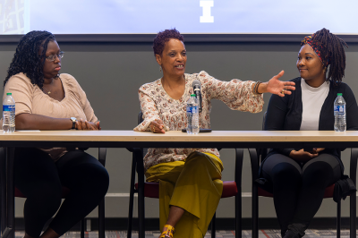 Three women panelists speaking at event